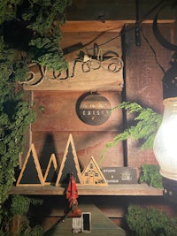 a wooden shelf with a lamp on it